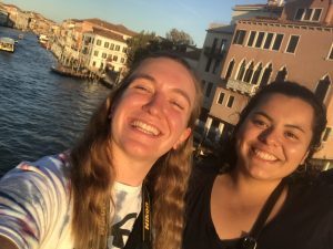 two women taking a selfie with the canals of Venice in the background