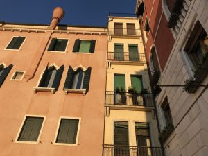 side of a tall Venetian building with windows