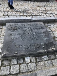 The plaque reads: "for ever let this place be a cry of despair and a warning to humanity, where the nazis murdered about one and a half million men, women, and children, mainly jews from various countries of Europe. 