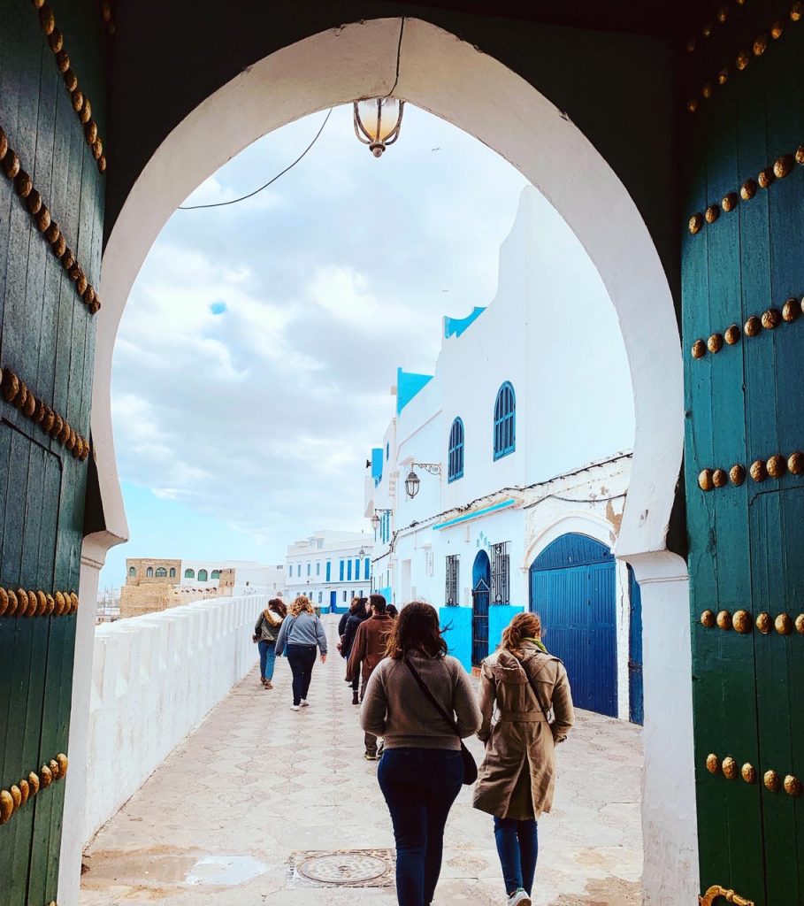 Students walking through an archway in a building in Morocco