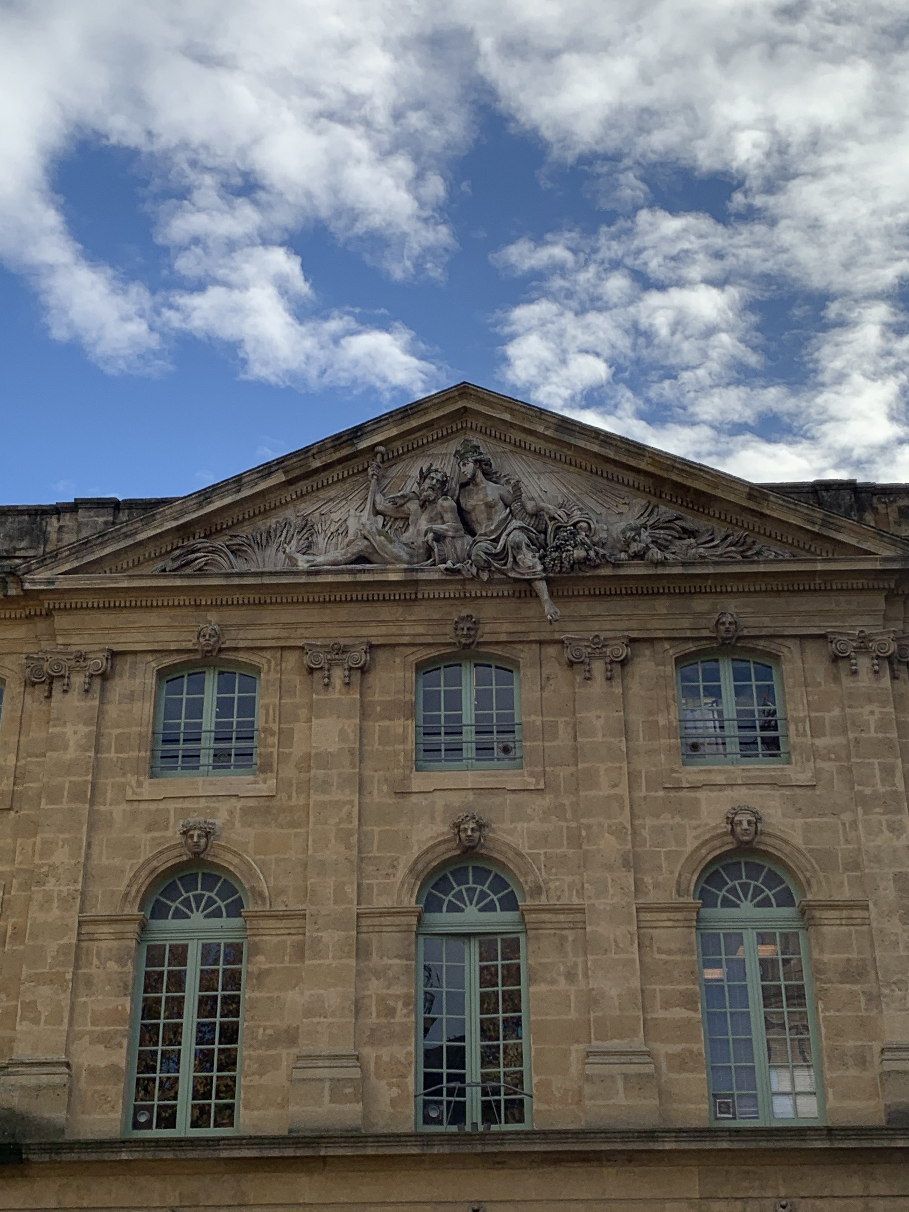 A historic building in Aix, France, with statuary along the top