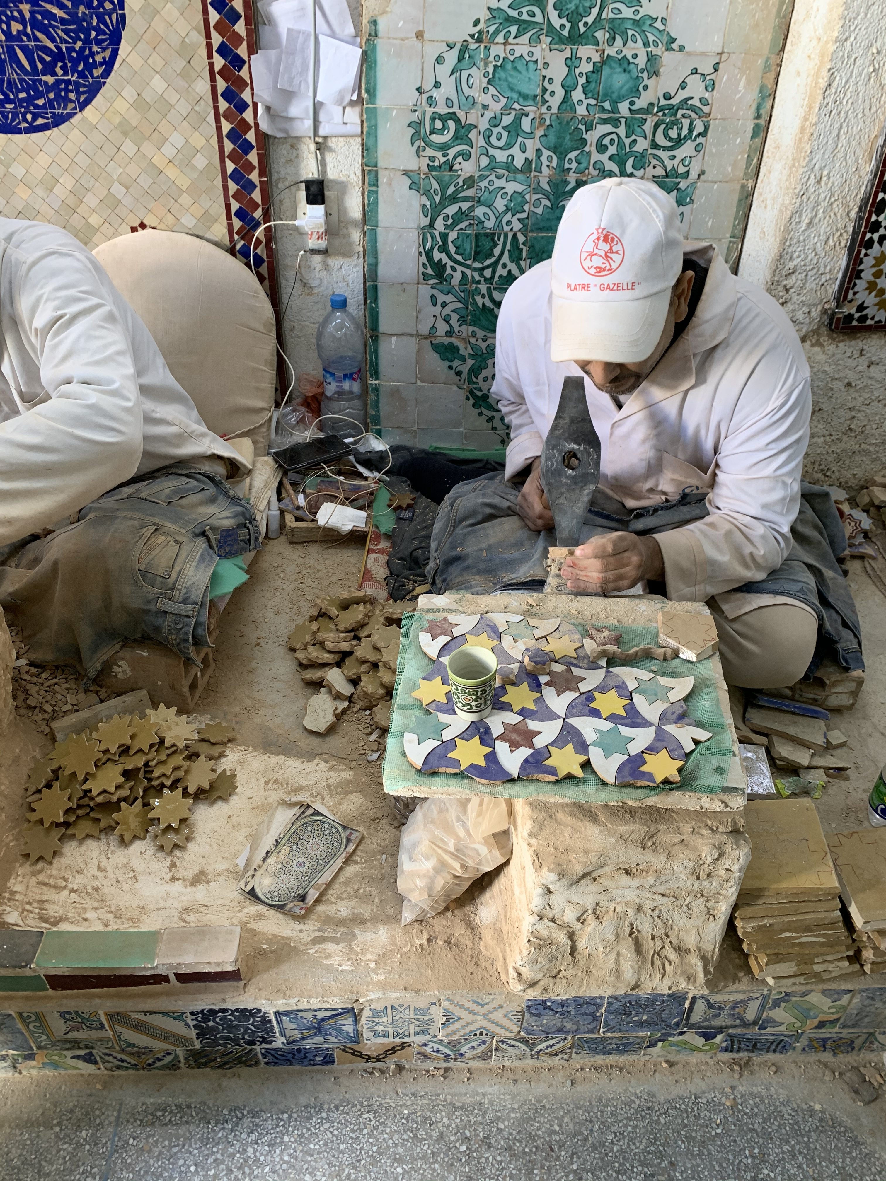 Man cutting beautiful painted tiles