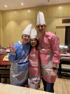 Aili, Will, and I in the kitchen wearing chef's hats.