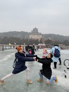 2 students posing on frozen lake in front of Summer Palace