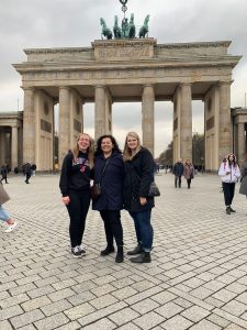 three women in front of the Brandenburg Gate in Berlin, Germany