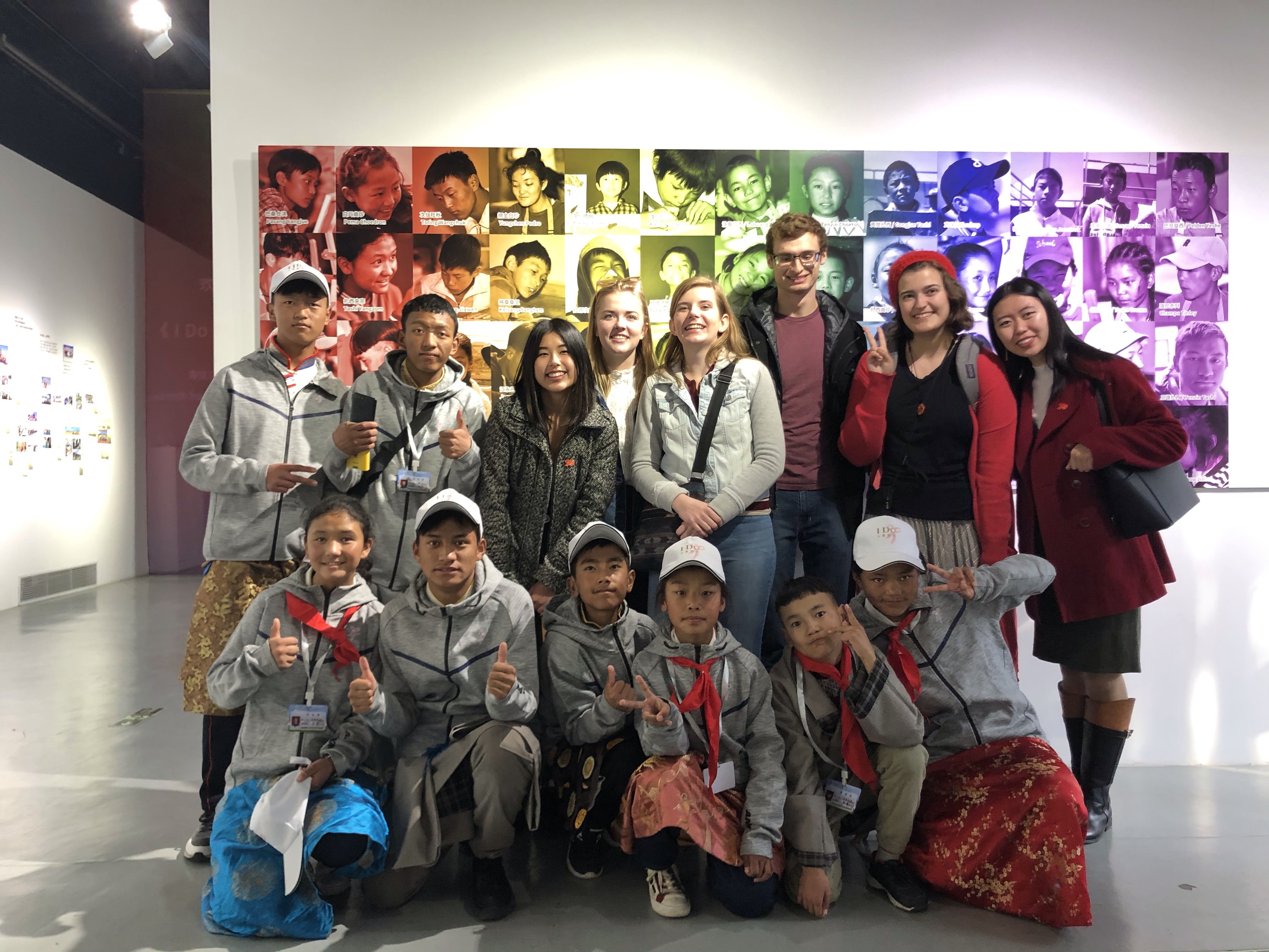Friends and I with the Tibetan students of the I Do Foundation in front of an exhibit.