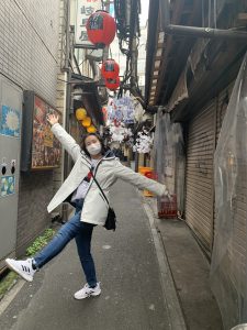 Girl striking a fun pose on a side street in Shinjuku.