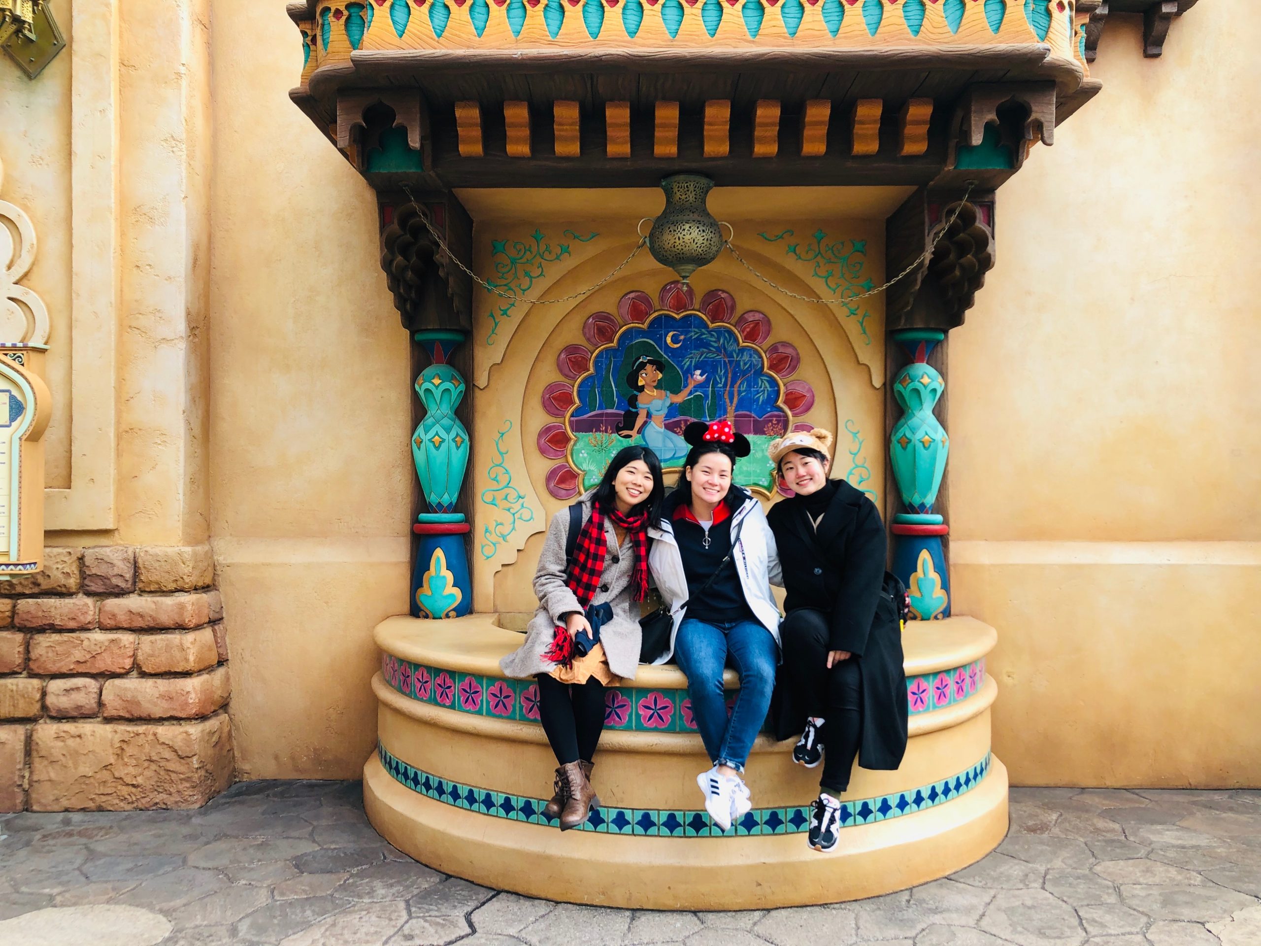 Me, Minami, and Risa posing in front of an Aladdin themed fountain