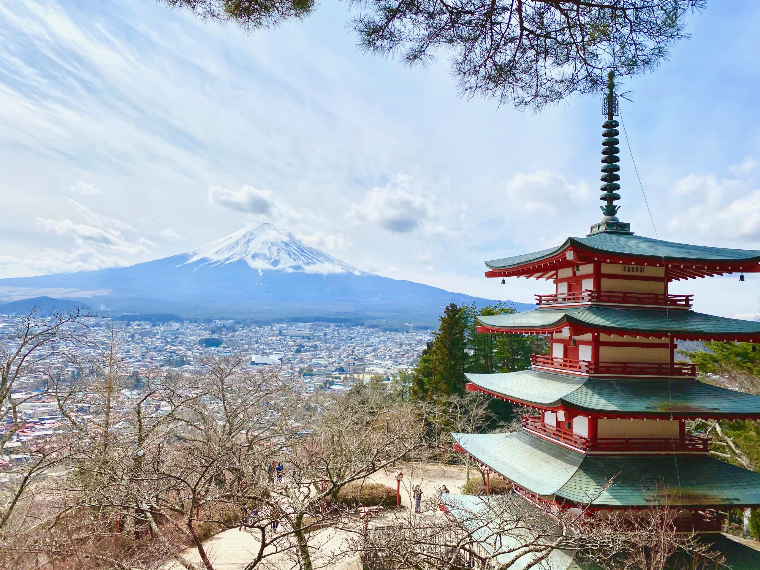 A beautiful sunny day with a red/green temple and Mt. Fuji in full view