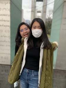 Two girls in front of the pillars of peace at Hiroshima.