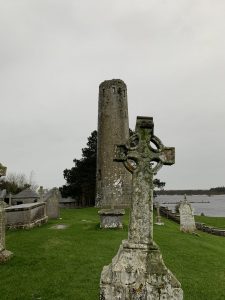 High Cross and Round Tower made of rock at Clonmacnoise.