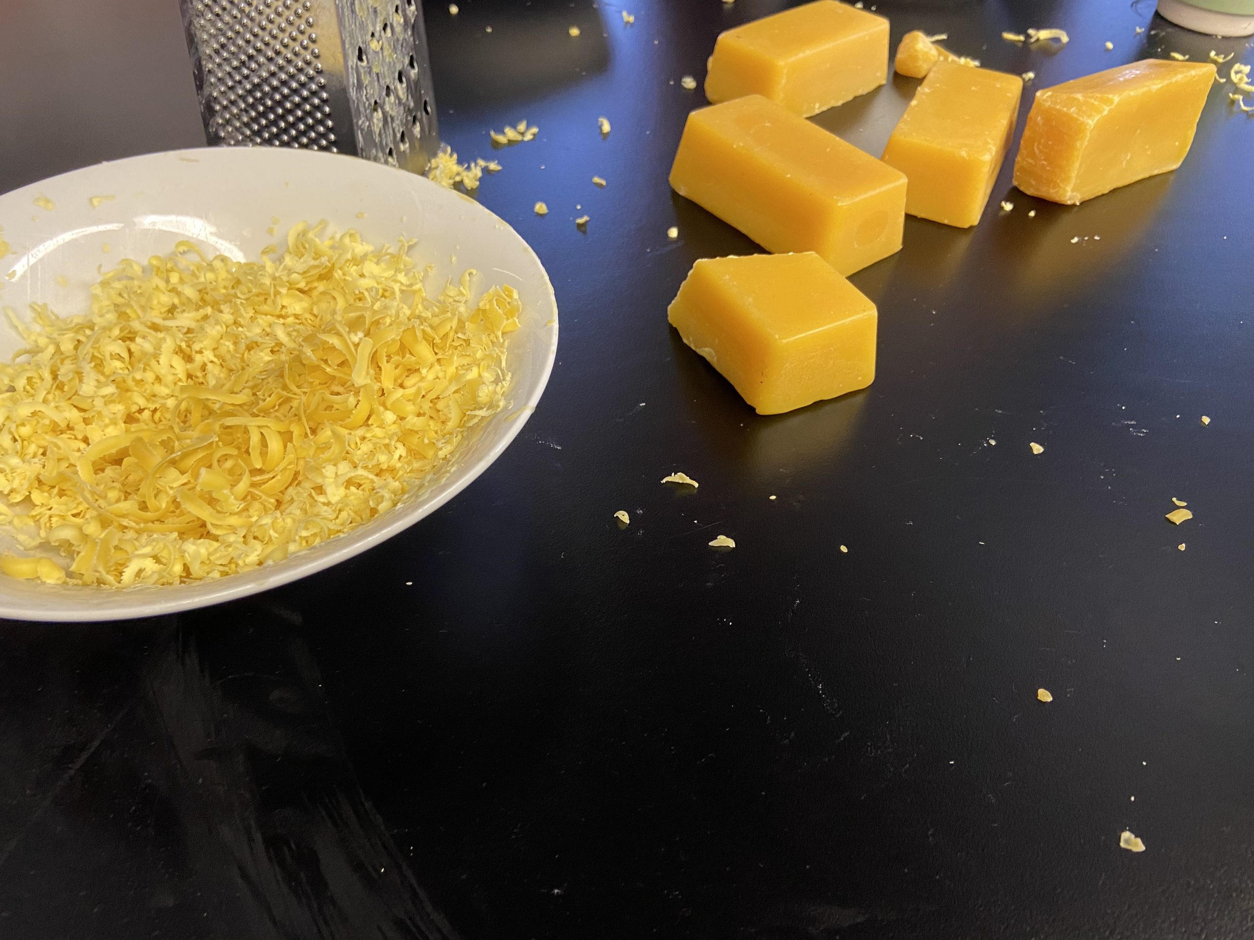Beeswax blocks and grated beeswax in a bowl