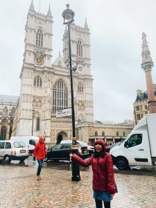 Student standing in front of tall church in London.