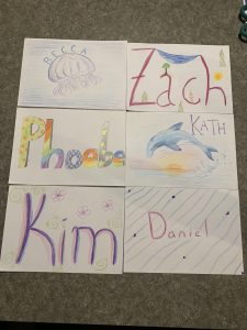 Six decorated signs with the flatmates' names on them.