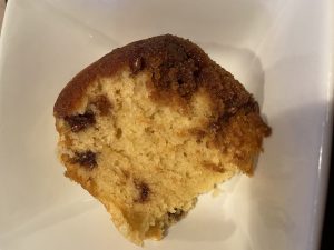 A slice of white pudding/cake with chocolate chips