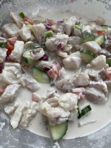 White fish in white sauce with sliced veggies