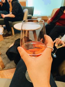 Enjoying a glass of rosé wine.