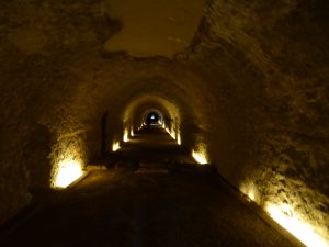 This photo showcases an illuminated tunnel in the Roman circus of Tarragona. The light emanates from the bottom of the tunnel walls.