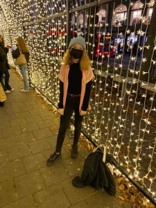 A person standing under the tunnel of lights.