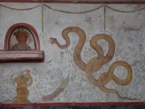 A serpent depicted in a stone wall carving.