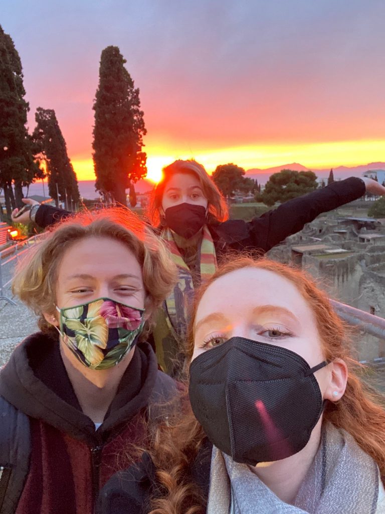 Students basking in the sunset over Herculaneum