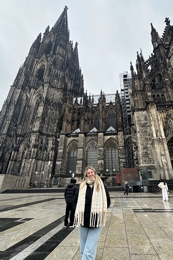 Kelsie standing in front of a cathedral while studying abroad.
