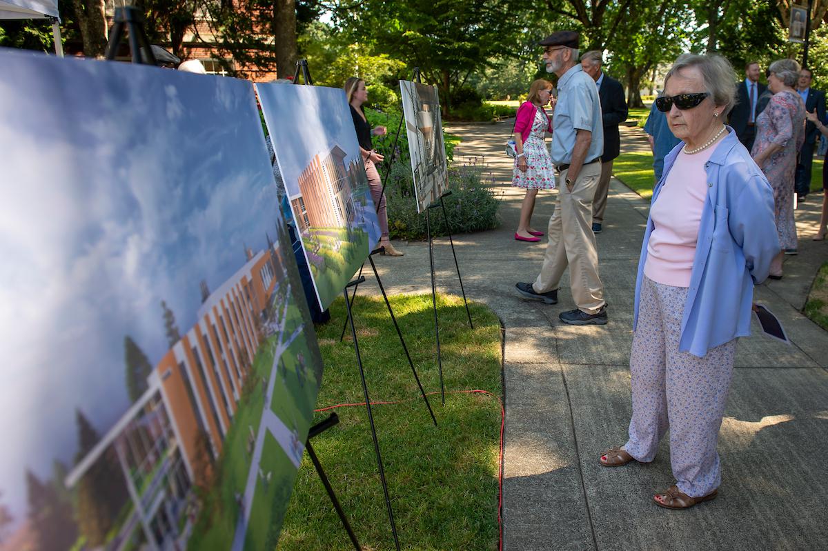 Cherie Walker, wife of former Linfield President Charles Walker, looks at renderings of the new Linfield University Science Complex