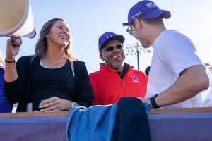Linfield University President Miles K. Davis interacts with students at a Linfield vs. Lewis & Clark football game, 2019